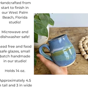 May include: A handmade ceramic mug with a blue glaze and green and white stripes. It holds 14 ounces and is approximately 4.5 inches tall and 3 inches wide. Microwave and dishwasher safe.