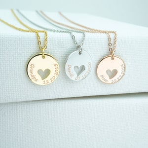 May include: Three gold, silver, and rose gold necklaces with round pendants featuring a heart cut-out and personalized text. The pendants read "Grandpa 12.20.2021", "Daniel 07.15.2020", and "Mom 10.25.2019".