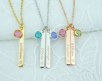 May include: Four personalized necklaces with bar pendants and small gemstone charms. The necklaces are in gold, silver, and rose gold. The names on the pendants are William, Olivia, Harleigh, and Kayden. The gemstones are pink, teal, blue, and green.