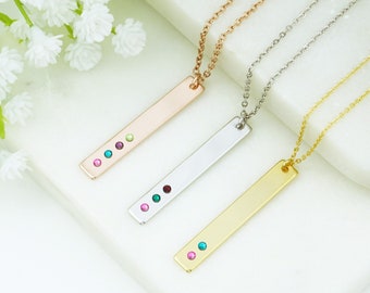 May include: Three bar necklaces with different colored gemstones. The necklaces are rose gold, silver, and gold. Each necklace has a bar pendant with three gemstones.