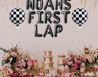 May include: Black and white checkered balloons with black letter balloons spelling "Noah's First Lap" on a pink tablecloth with a table decorated with flowers and desserts.