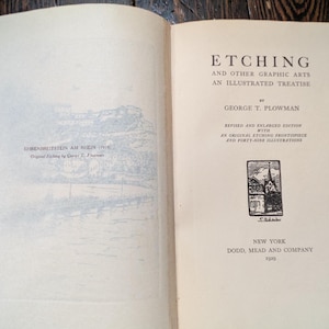 May include: Open book with the title "Etching and Other Graphic Arts: An Illustrated Treatise" by George T. Plowman. The book is a revised and enlarged edition with an original etching frontispiece and forty-nine illustrations. Published in New York by Dodd, Mead and Company.