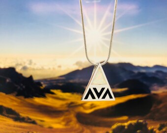 May include: A silver necklace with a triangular pendant featuring a white opal stone and the name "AVA" inscribed in black.