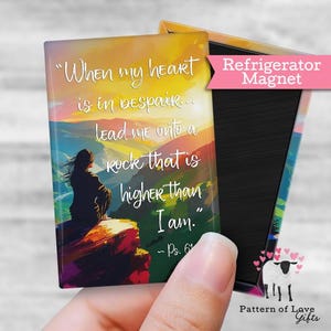 May include: A rectangular refrigerator magnet with a colorful landscape design and the quote "When my heart is in despair... lead me onto a rock that is higher than I am." The magnet has a pink banner that says "Refrigerator Magnet".