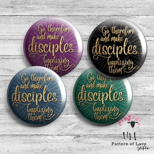 May include: Four round buttons with a gold inscription that reads "Go therefore and make disciples... baptizing them." The buttons are in four different colors: purple, black, blue, and green.