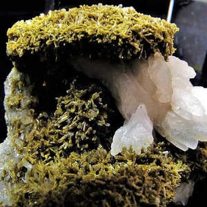 May include: A cluster of white, translucent crystals with a layer of green, fibrous crystals on top. The crystals are arranged in a natural, organic pattern.