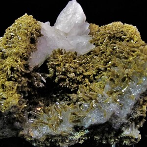 May include: A cluster of clear quartz crystals with a green mineral, possibly actinolite, growing on the surface. The quartz crystals are clear and have a glassy lustre. The actinolite is a dark green colour and has a fibrous texture.