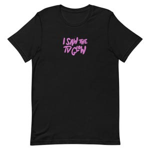 May include: Black t-shirt with the text "I SAW THE TV GLOW" in pink lettering.