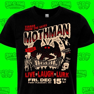 May include: Black t-shirt with a Mothman graphic, including the phrases "Terror From The Skies" and "Live Laugh Lurk." The design features a bridge, skeleton, and the date "Fri. Dec 15th '67." The shirt also has the text "No Sissies Allowed."