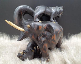 Decorative wooden figure "Two lions fight with elephant"