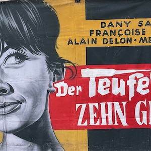 May include: Vintage movie poster featuring a black and white portrait of a woman with dark hair. The poster has text in German, including the title "Der Teufel und die Zehn Gebote" in white on a red banner. The background is yellow.