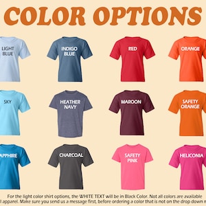 May include: A chart showing 12 different t-shirt colors with the color name printed in white on each shirt. The colors are: Light Blue, Indigo Blue, Red, Orange, Sky, Heather Navy, Maroon, Safety Orange, Sapphire, Charcoal, Safety Pink, and Heliconia.