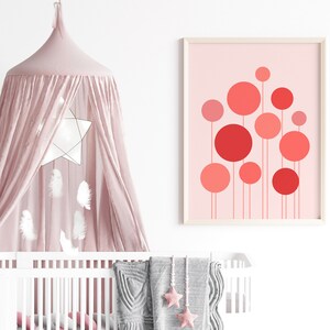 May include: A pink and white nursery with a white crib, a pink canopy, and a framed print of red and pink circles on a pink background.