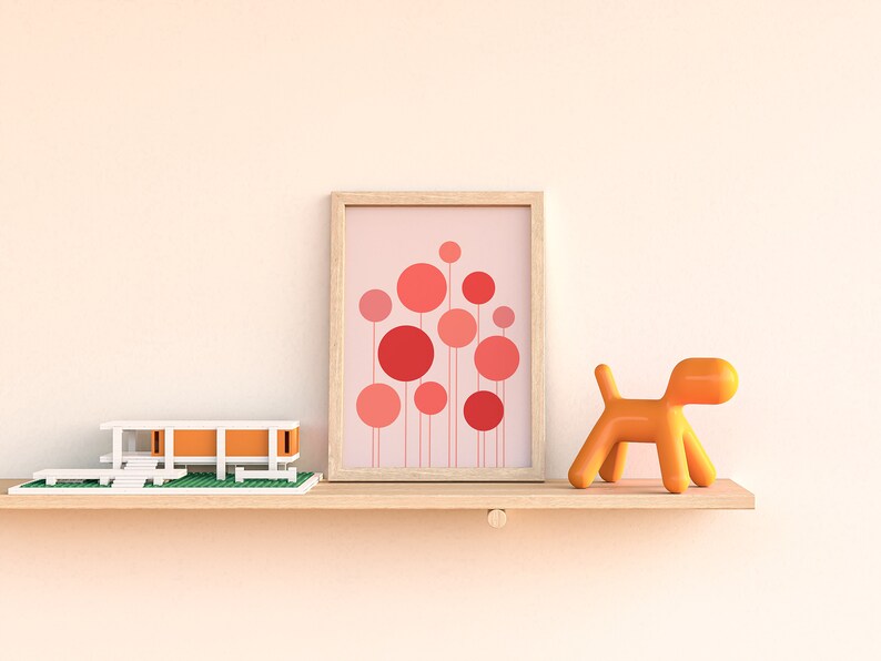 May include: A wooden shelf with a white and orange model house, a framed print of pink and red circles, and an orange plastic dog figurine.