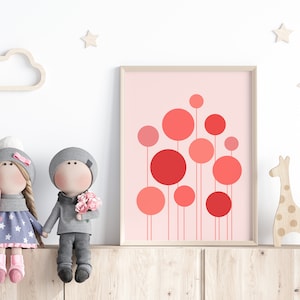May include: A framed print with a pink background and red circles of varying sizes. The print is hanging on a wall above a wooden shelf with two dolls and a giraffe figurine.