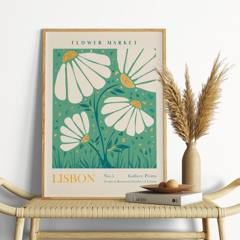 May include: A framed poster with a green background and white flowers with yellow centers. The poster says "FLOWER MARKET" at the top and "LISBON No.5 Gallery Prints Tropical Botanical Garden of Lisbon" at the bottom.