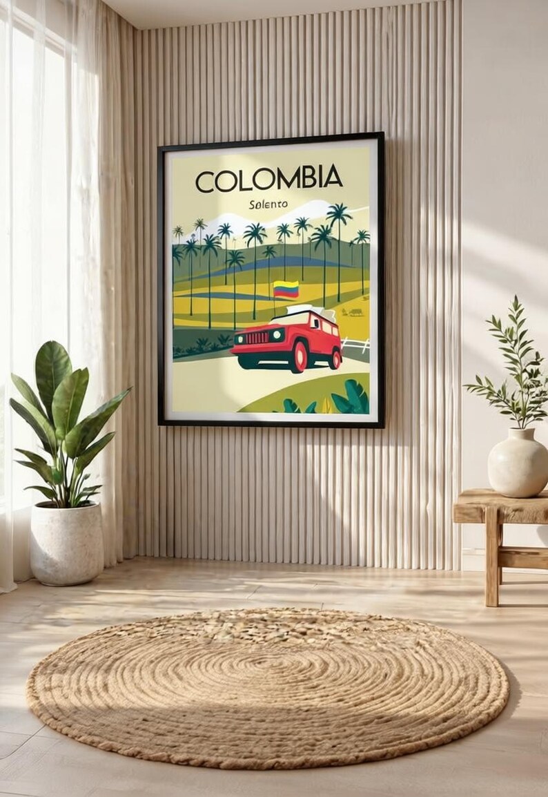 May include: Framed poster featuring a stylized illustration of Colombia's Solento region. The artwork depicts a red vehicle on a road, palm trees, and the Colombian flag. The poster is displayed in a room with a neutral color palette.