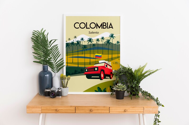 May include: A framed art print featuring a stylized landscape of Colombia's Salento region. The print showcases a red vehicle, palm trees, and the Colombian flag. The word "COLOMBIA" is at the top.