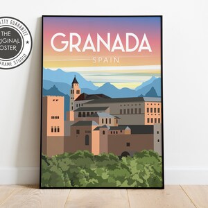 May include: A framed art print featuring a stylized illustration of Granada, Spain. The artwork depicts the city's architecture with a colorful sky and mountains in the background. The text "Granada Spain" is displayed prominently.