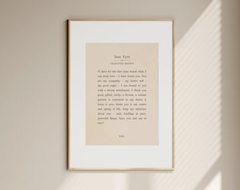 May include: A framed print of text from Charlotte Brontë's "Jane Eyre". The text is on a cream background, within a gold frame. The quote is from the novel and is in black text.