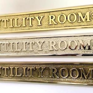 Utility room door sign available in three finishes - silver nickel, antique bronze or brass. Matching screws included. 20.5 cm X 3.5cm.