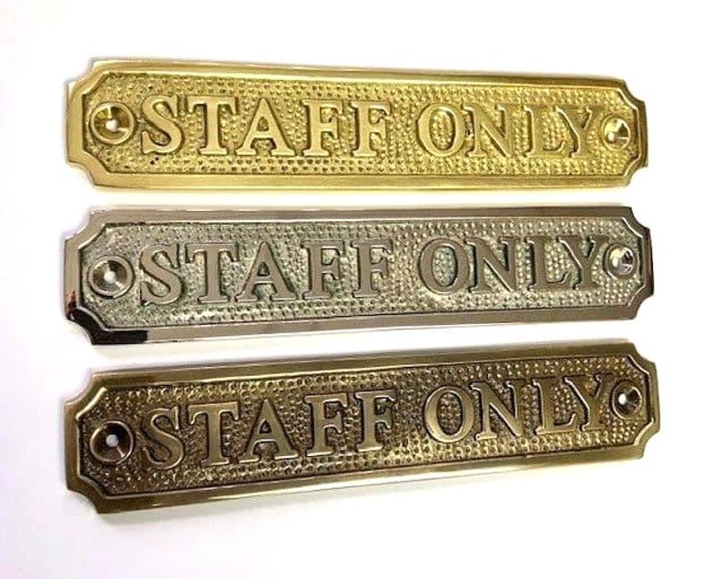 May include: Three rectangular metal signs with rounded corners, each featuring the embossed text "STAFF ONLY" in capital letters. The background of each sign has a textured, hammered finish, and each end includes a pre-drilled hole for mounting.