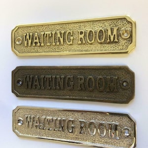 Waiting room door sign available in three finishes - nickel, antique bronze or brass. Matching screws are included. 13 cm X 3.5 cm.