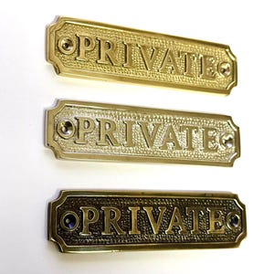 Private door sign available in three finishes - nickel, antique bronze or brass. Matching screws are included. 13.2 cm X 3.4 cm.