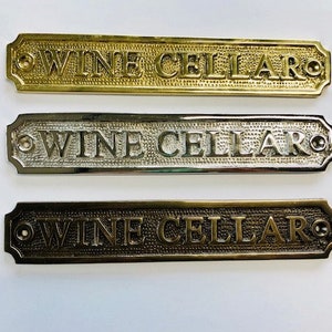 Wine cellar door sign available three finishes - nickel, antique bronze or brass. Matching screws are included.Size 19.4 cm X 3.5 cm approx.