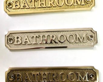 Bathroom door sign available in three finishes - nickel, antique bronze or brass. Matching screws are included. 16.2 cm X 3.3 cm.
