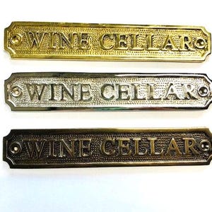 Wine cellar door sign available three finishes - nickel, antique bronze or brass. Matching screws are included.Size 19.4 cm X 3.5 cm approx.