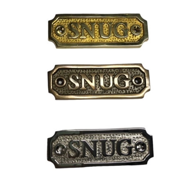 SNUG door sign made from solid brass with a choice of finish. Brass, nickel or antique bronze. The plaque comes with screws, 9.8x3.3x0.4cm.
