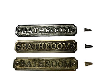 Bathroom door sign available in three finishes - nickel, antique bronze or brass. Matching screws are included. 16.2 cm X 3.3 cm.