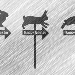 May include: Three black silhouette bunny rabbit figures on wooden stakes with arrows pointing to the right. Each stake has a sign that reads "Happy Easter".