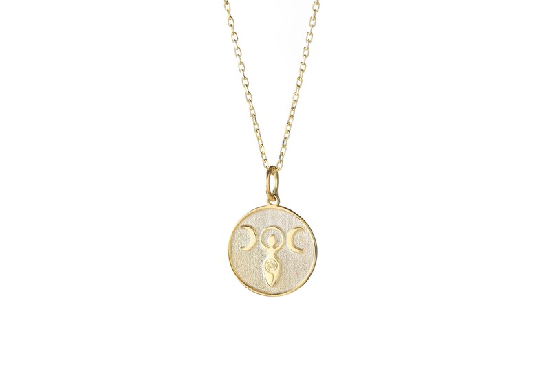 May include: A gold necklace with a round pendant featuring a stylized image of a woman with three crescent moons above her head.