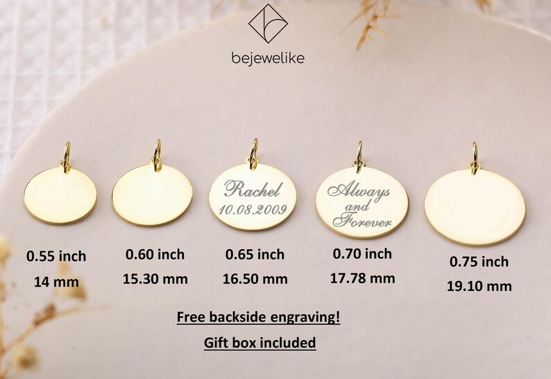 May include: Five gold-colored round pendants of different sizes with a loop at the top. The pendants are blank except for the middle one, which has the text "Rachel 10.08.2009" engraved on it. The pendant to the right of the middle one has the text "Always and Forever" engraved on it. The pendants are arranged in a row from left to right, with the smallest pendant on the left and the largest pendant on the right. The pendants are on a white background. The text below the pendants indicates the size of each pendant in inches and millimeters.