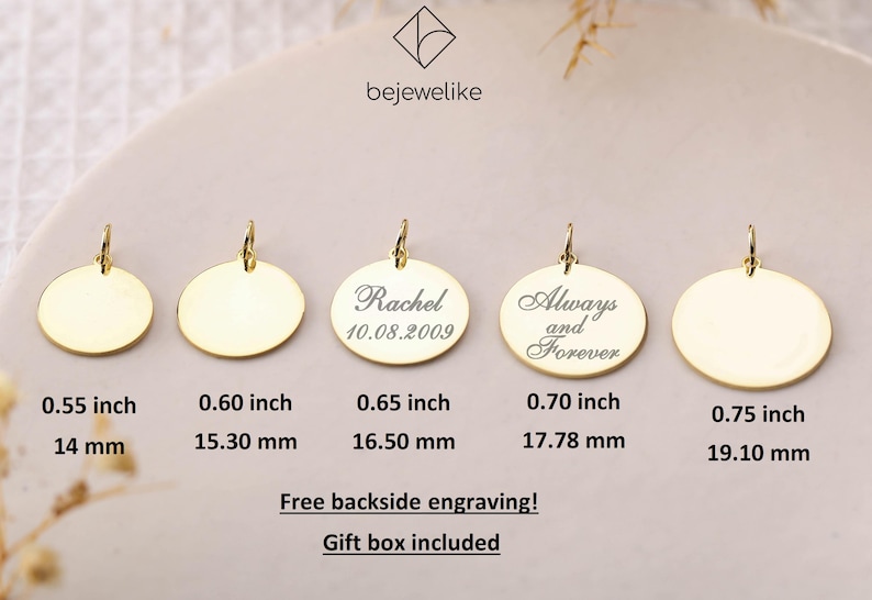 May include: Five gold-colored round pendants of different sizes with a loop at the top. The pendants are blank except for the middle one, which has the text "Rachel 10.08.2009" engraved on it. The pendant to the right of the middle one has the text "Always and Forever" engraved on it. The pendants are arranged in a row from left to right, with the smallest pendant on the left and the largest pendant on the right. The pendants are on a white background. The text below the pendants indicates the size of each pendant in inches and millimeters.