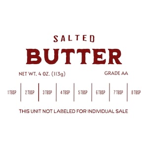 May include: A red and white label for salted butter with the text "SALTED BUTTER" in a large, bold font. The label also includes the text "NET WT. 4 OZ. (113g)" and "GRADE AA". There are eight measurements listed below the text, each labeled with "TBSP". The text "THIS UNIT NOT LABELED FOR INDIVIDUAL SALE" is printed at the bottom of the label.
