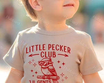 May include: A tan toddler t-shirt with red text that reads "Little Pecker Club" with arrows pointing in opposite directions. A cartoon bird wearing sunglasses is perched on a branch with the text "Lil Gents Makin' Dents" below.