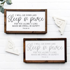 May include: Two wooden signs with a white background and brown frame. The signs feature the text "I will lie down and Sleep in peace for you alone o Lord. Make me dwell in safety Psalm 48".
