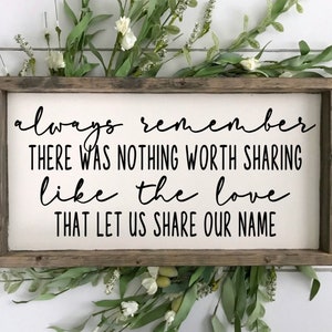 May include: A wooden sign with a white background and black text that reads "always remember there was nothing worth sharing like the love that let us share our name". The sign is framed in a rustic brown wood frame.