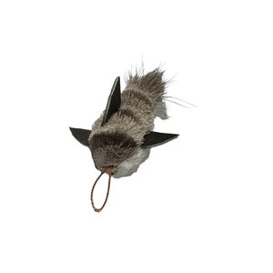 May include: A gray and black plush toy shaped like a shark with a brown string attached to the top. The toy is designed to be a cat toy.
