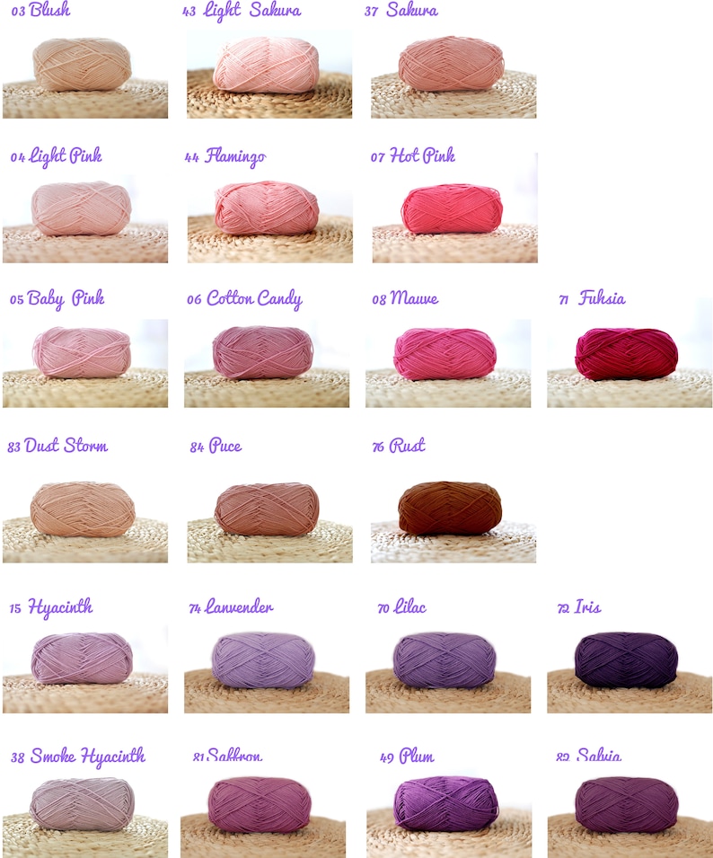 May include: A collection of yarn balls in various shades of pink, purple, and brown. The yarn balls are arranged in rows on a woven surface. The yarn balls are labelled with numbers and names, such as "Blush", "Light Sakura", "Hot Pink", "Dust Storm", "Hyacinth", "Smoke Hyacinth", "Saffron", "Plum", and "Sahvia".