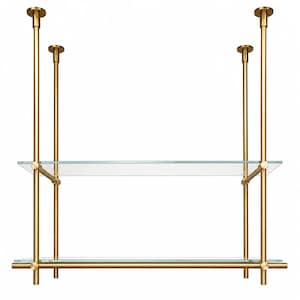 May include: A two-tier shelving unit featuring two clear glass shelves supported by a brass-toned metal frame. The structure consists of four vertical poles with circular ceiling mounts and horizontal bars that secure the glass panels in place.