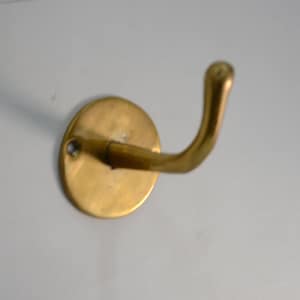 Set di ganci in ottone non laccato per parete e porta