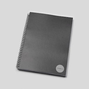 May include: A black spiral bound notebook with a white circle logo that says "dotcard.co" on the bottom right corner.