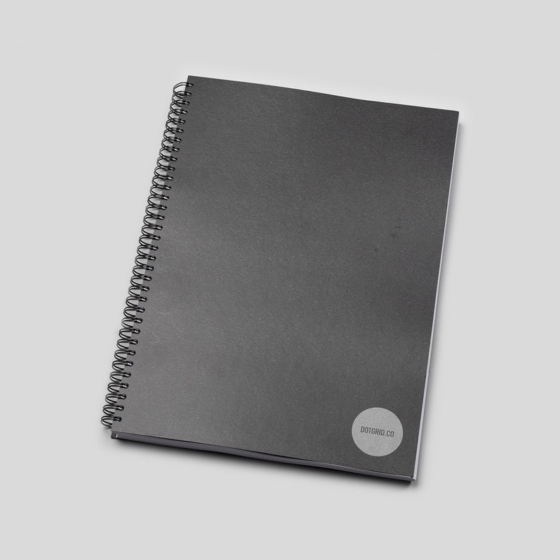May include: A black spiral bound notebook with a white circle logo that says "dotcard.co" on the bottom right corner.