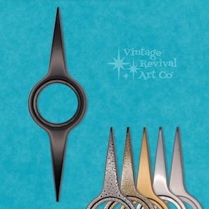 May include: Black metal clock hand with a circular design. The hand is pointed upwards. The hand is part of a set of clock hands in different finishes.