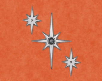 May include: Three silver star-shaped wall sconces with a modern design. The sconces have a pointed center and six points radiating out from the center. The sconces are on a textured orange background.