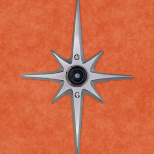 May include: A silver star-shaped door knocker with a black peephole in the center.